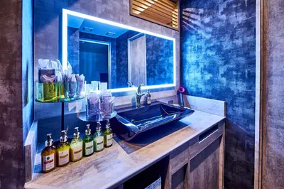 a bathroom with a sink and a mirror at Hotel BaliAn Resort Shinjuku Glamping in Tokyo