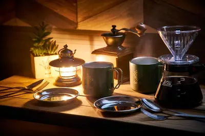 a kitchen counter with a blender and plates and utensils at Hotel BaliAn Resort Shinjuku Glamping in Tokyo