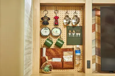 a wall with dishes and utensils on it at Hotel BaliAn Resort Shinjuku Glamping in Tokyo
