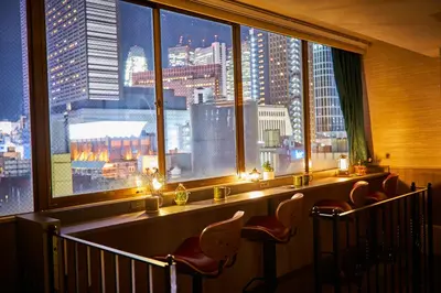 a room with a window with a view of a city at Hotel BaliAn Resort Shinjuku Glamping in Tokyo