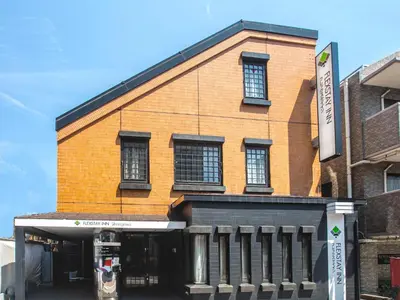 a brick building with a parking meter in front of it at FLEXSTAY INN Shinagawa in Tokyo