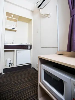 a small kitchen with a sink and a microwave at FLEXSTAY INN Shinagawa in Tokyo