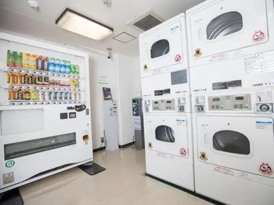 a row of white washers and dryers in a store at FLEXSTAY INN Shinagawa in Tokyo