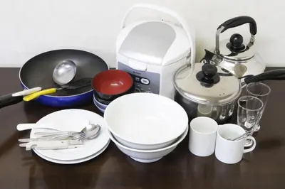 a table with plates and cups and a coffee maker at FLEXSTAY INN Shinagawa in Tokyo
