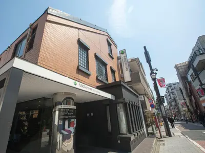 a building with a parking meter in front of it at FLEXSTAY INN Shinagawa in Tokyo