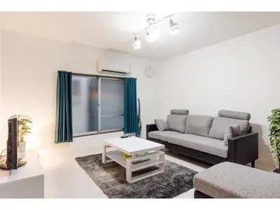 a living room with a couch and a table at Gracias Arakawa - Vacation STAY 81702v in Tokyo