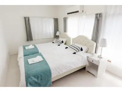 a white bedroom with a white bed and a window at Gracias Arakawa - Vacation STAY 81702v in Tokyo