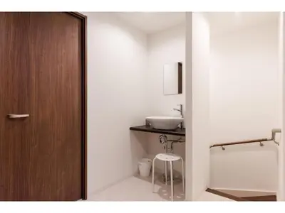a bathroom with a wooden door and a sink at Gracias Arakawa - Vacation STAY 81702v in Tokyo