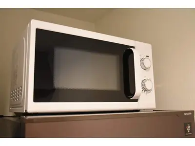 a microwave oven sitting on top of a refrigerator at Gracias Arakawa - Vacation STAY 81702v in Tokyo