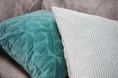 a green pillow sitting on top of a couch at \u3077\u3075\u304b\u5c0f\u6885 in Tokyo