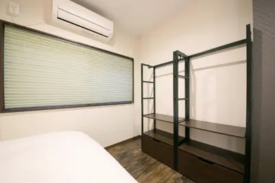 a bedroom with a bed and a window at \u3077\u3075\u304b\u5c0f\u6885 in Tokyo