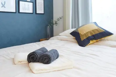 two towels on top of a white bed at Hotel Estasia Ryogoku in Tokyo