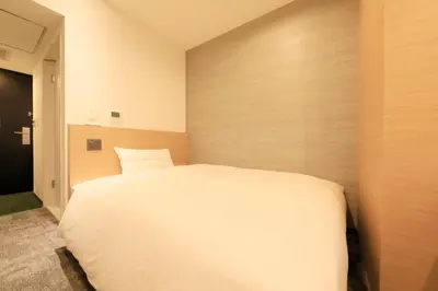 a bedroom with a large white bed in it at Via Inn Prime Akasaka in Tokyo