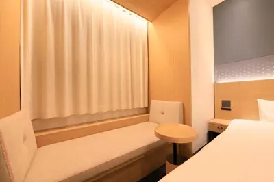 a small room with a bed and a window at Via Inn Prime Akasaka in Tokyo