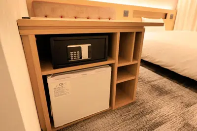 a microwave in a cabinet in a hotel room at Via Inn Prime Akasaka in Tokyo