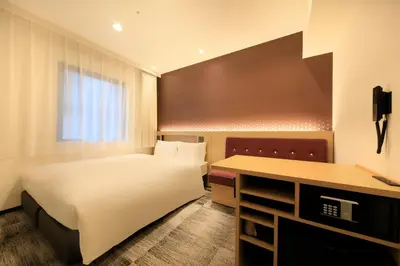 a hotel room with a bed and a desk at Via Inn Prime Akasaka in Tokyo