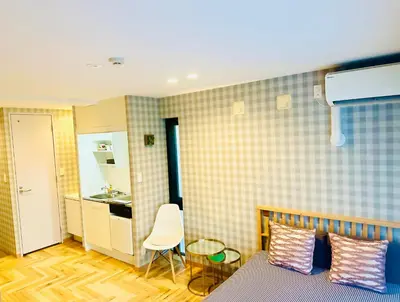 a small room with a bed and a kitchen at TIME SHARING STAY Ikebukuro in Tokyo