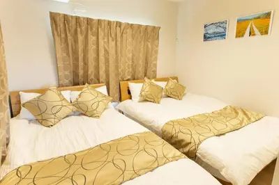 two beds in a small room withskirts at My Home in Tokyo - Vacation STAY 73241v in Tokyo