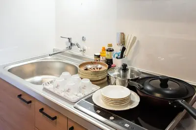 a kitchen with a sink and a stove with dishes at My Home in Tokyo - Vacation STAY 73241v in Tokyo