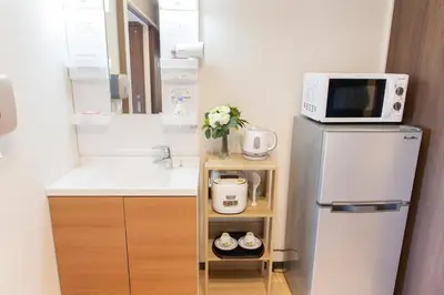 a small kitchen with a refrigerator and a microwave at My Home in Tokyo - Vacation STAY 73241v in Tokyo