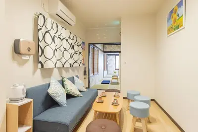 a living room with a blue couch and a table at My Home in Tokyo - Vacation STAY 73238v in Tokyo