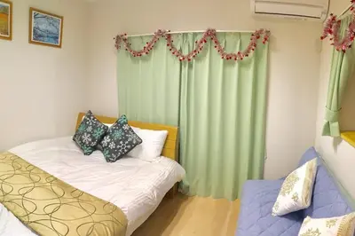 a bedroom with a bed and a green curtain at My Home in Tokyo - Vacation STAY 73228v in Tokyo