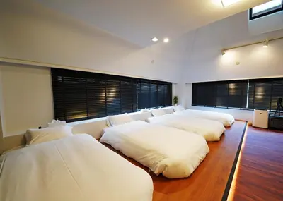 a group of four beds in a room at Ryoma THE TOWER - Vacation STAY 12892 in Tokyo