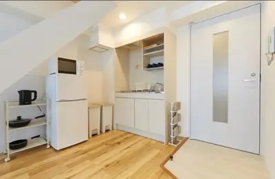 a kitchen with white cabinets and a sliding door at HOTEL ESTASIA Ryogoku - Vacation STAY 53008v in Tokyo