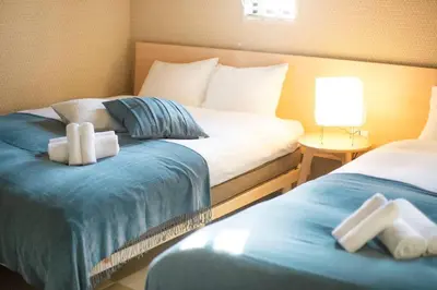 a hotel room with two beds with towels on them at Ciel-home in Tokyo