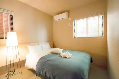 a bedroom with a bed with a stuffed animal on it at Ciel-home in Tokyo