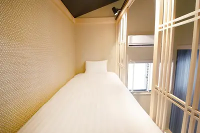 a bed in a room with a window at Ciel-home in Tokyo