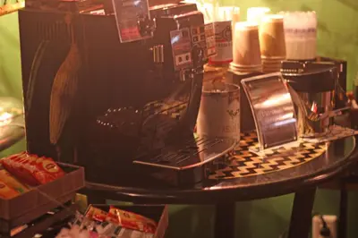 a table with a coffee maker and a laptop on it at Hotel OLDSWING Adult Only in Tokyo