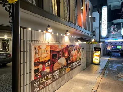 a building with posters on the side of a street at Hotel OLDSWING Adult Only in Tokyo