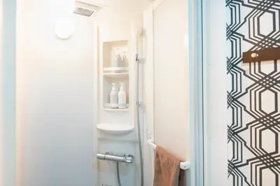 a bathroom with a shower and a toilet in it at 15 min Shinjuku ! Kitchen,Laundry! Perfect for a Long Stay I many facilities nearby I Shinjuku,Tokyo in Tokyo