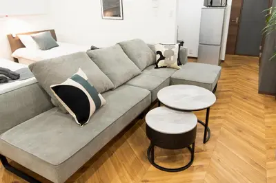 a living room with a couch and two tables at 15 min Shinjuku ! Kitchen,Laundry! Perfect for a Long Stay I many facilities nearby I Shinjuku,Tokyo in Tokyo