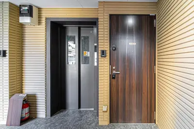 a wooden door on a building with at 15 min Shinjuku ! Kitchen,Laundry! Perfect for a Long Stay I many facilities nearby I Shinjuku,Tokyo in Tokyo