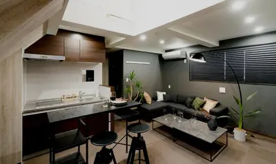 a kitchen and living room with a couch and a table at 15 min Shinjuku ! Kitchen,Laundry! Perfect for a Long Stay I many facilities nearby I Shinjuku,Tokyo in Tokyo