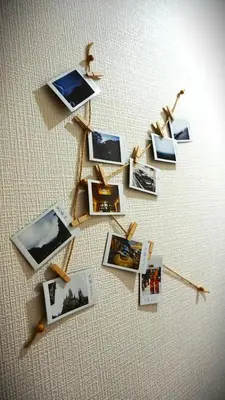 a group of photos on a wall with arrows at K.House in Tokyo