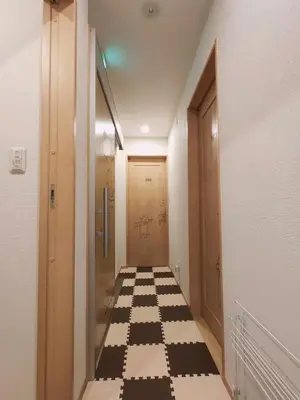 a hallway with a black and white checkered floor at K.House in Tokyo