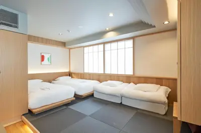 a room with two beds and a window at COCOSHUKU AKASAKA Premium in Tokyo