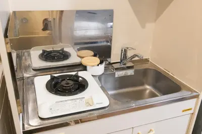 a small kitchen with a stove and a sink at Near Ikebukuro, Kitchen & Laundry, Fast Wi-Fi, 4min to Station,Many restaurants nearby!! in Tokyo