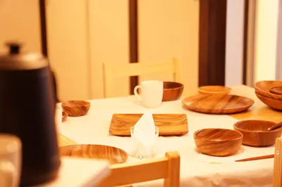 a table with wooden bowls and cups on it at \u5317\u65b0\u5bbf\u30a6\u30c3\u30c9\u30a6\u30a9\u30fc\u30eb\u30b9\u30c6\u30a4 in Tokyo