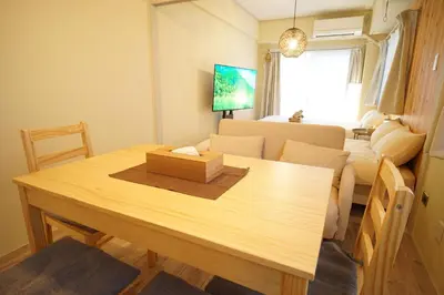 a room with a dining table and a living room at \u5317\u65b0\u5bbf\u30a6\u30c3\u30c9\u30a6\u30a9\u30fc\u30eb\u30b9\u30c6\u30a4 in Tokyo