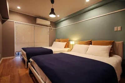 a bedroom with two beds and a window at KANDA HOUSE!! Shin-Okubo Walkable Modern Stay with Shinjuku Access in Tokyo