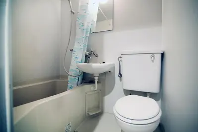 a small bathroom with a toilet and a sink at KANDA HOUSE!! Shin-Okubo Walkable Modern Stay with Shinjuku Access in Tokyo