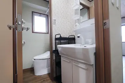 a bathroom with a sink and a toilet at KANDA HOUSE!! Shin-Okubo Walkable Modern Stay with Shinjuku Access in Tokyo