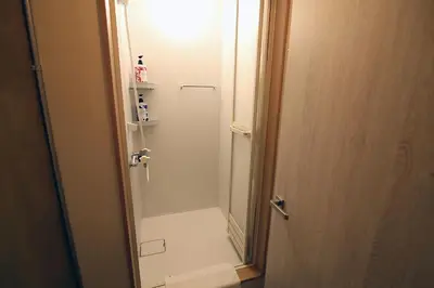 a bathroom with a shower and a toilet in it at KANDA HOUSE!! Shin-Okubo Walkable Modern Stay with Shinjuku Access in Tokyo