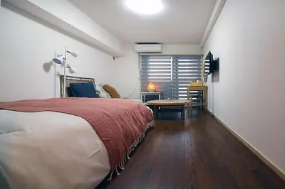 a bedroom with a bed and a table in it at GM Shinjuku in Tokyo