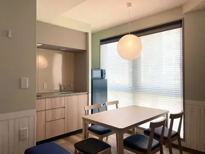 a kitchen and dining room with a table and chairs at KOKO HOTEL Residence Asakusa Tawaramachi in Tokyo