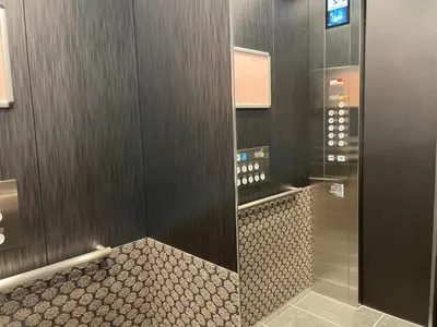 a bathroom with a walk in shower with a tile floor at KOKO HOTEL Residence Asakusa Tawaramachi in Tokyo